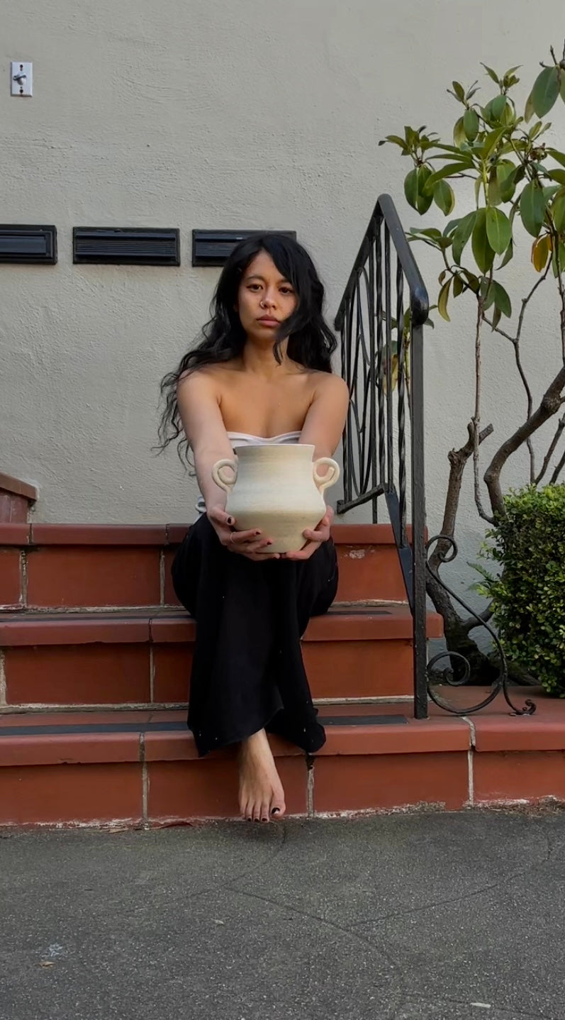The hands behind the pottery